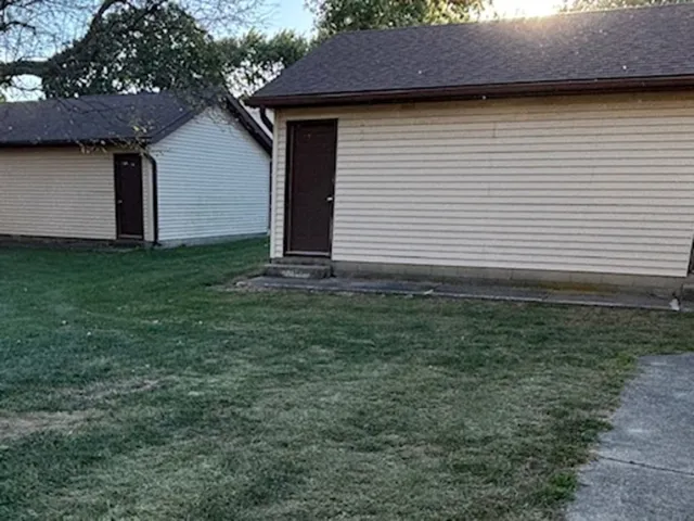 a view of a house with a yard and garage