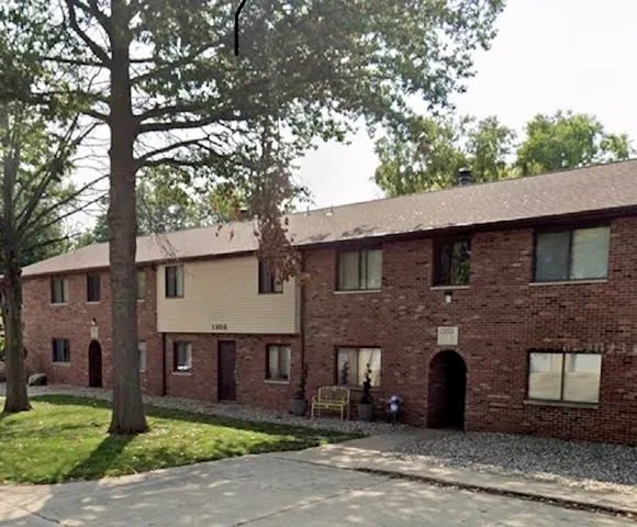 a brick house with a large tree
