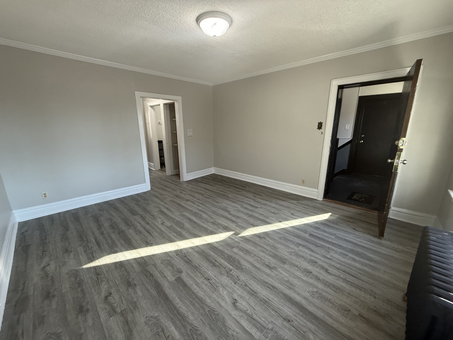 6443 23rd Street, Unit 12 Berwyn, IL 60402 - Photo 2 of 9 an empty room with wooden floor and closet