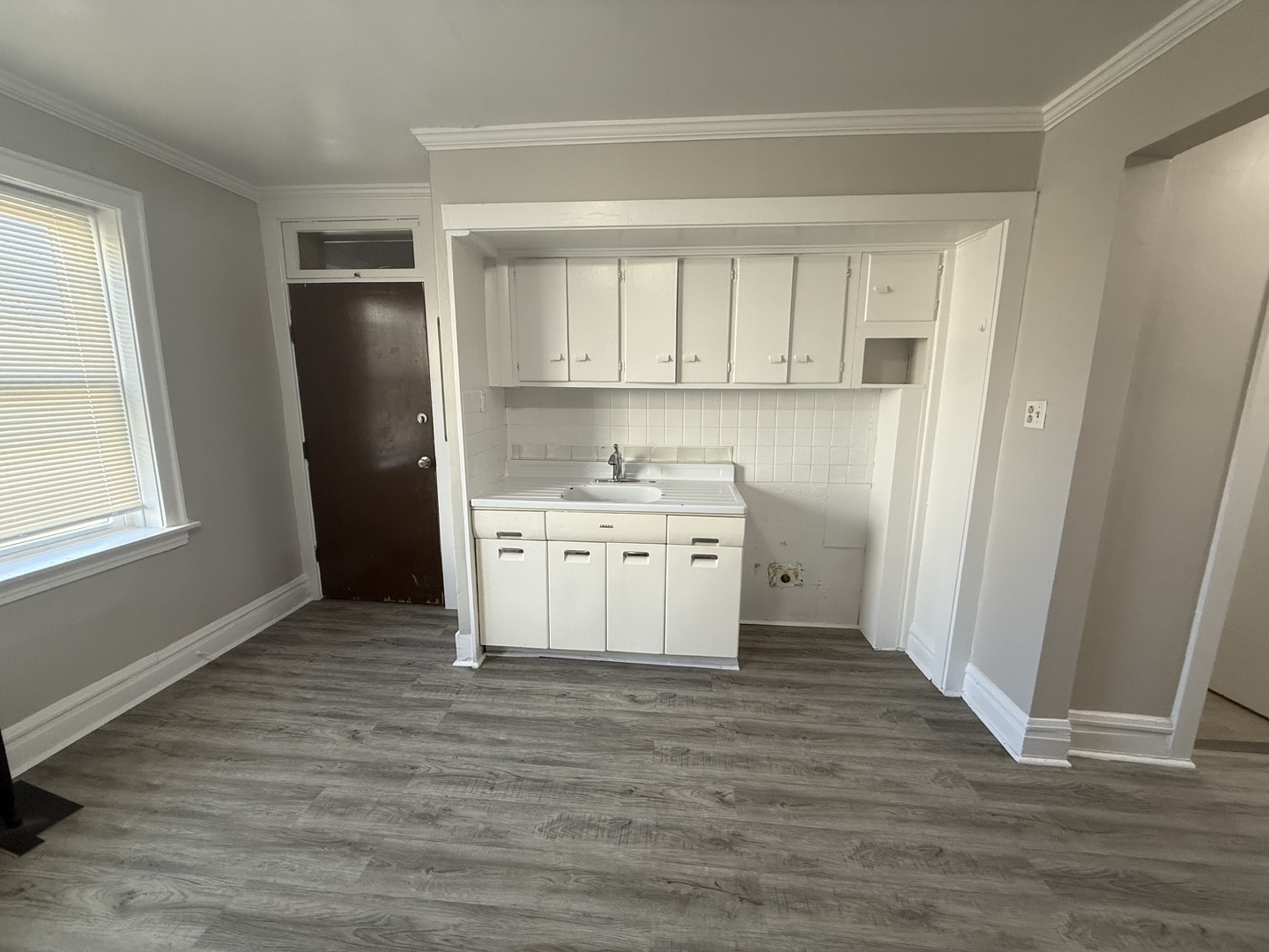 6443 23rd Street, Unit 12 Berwyn, IL 60402 - Photo 6 of 9 a view of a kitchen with wooden floor and electronic appliances