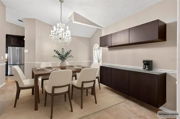 a dining room with furniture a chandelier and window
