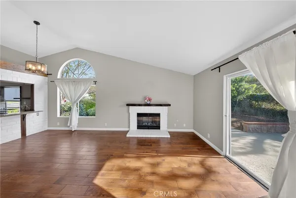a view of an empty room and fire place