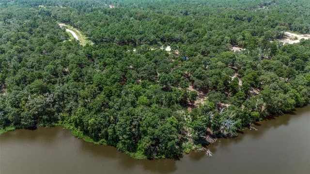 an aerial view of residential house with outdoor space and trees around