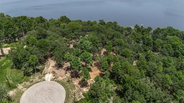 an aerial view of a house with a yard and outdoor seating