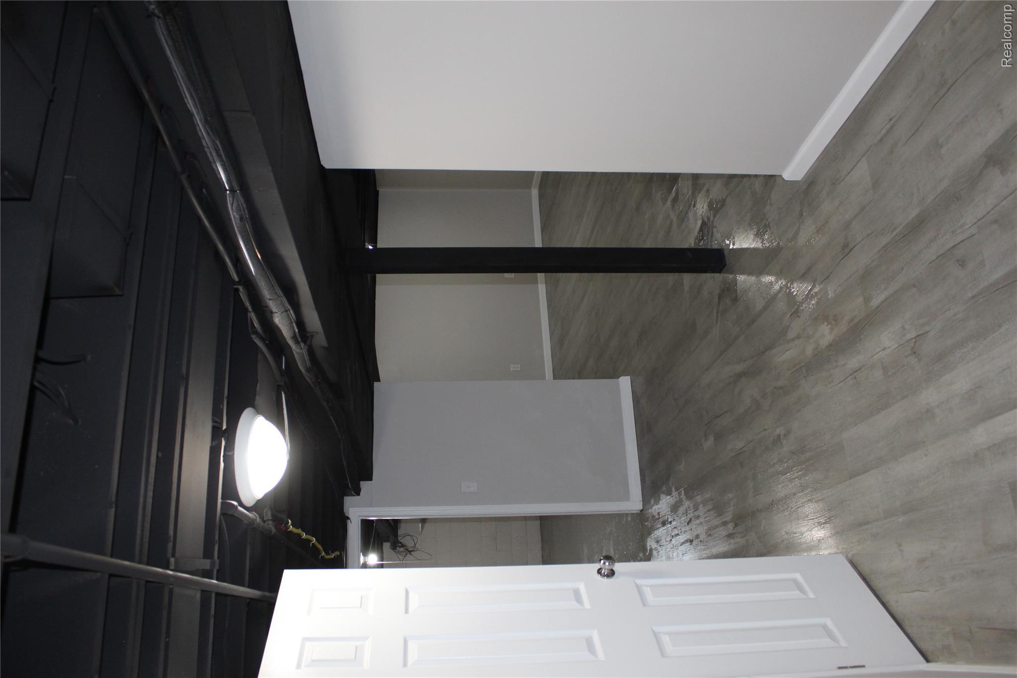 5543 Balfour Road Detroit, MI 48224 - Photo 34 of 54 Finished lower level with contemporary gray wood-finish flooring, white baseboards, and light gray painted walls