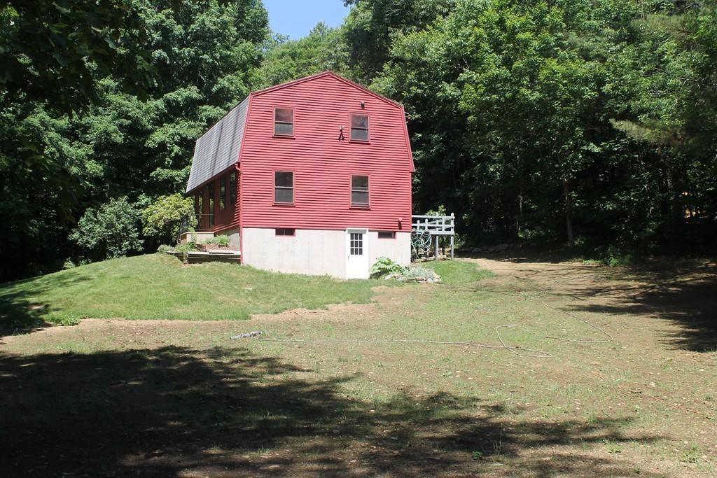 1887 North Brookfield Road Oakham, MA 01068 - Photo 6 of 23 a front of a house with a yard