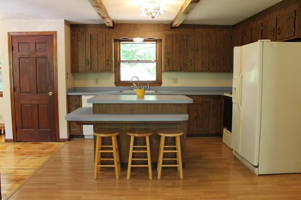 1887 North Brookfield Road Oakham, MA 01068 - Photo 8 of 23 a kitchen with a wooden table and chairs