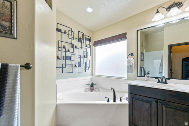 210 Talon Court Ivins, UT 84738 - Photo 34 of 60 Bathroom with a bath, vanity, and recessed lighting