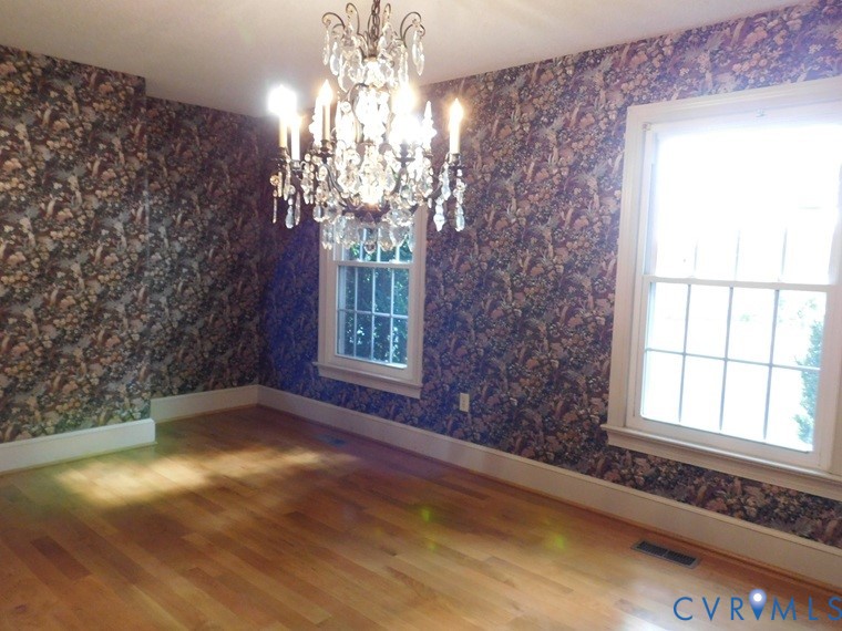 838 Crymes Road Keysville, VA 23947 - Photo 19 of 49 Unfurnished dining area with a chandelier, wallpap