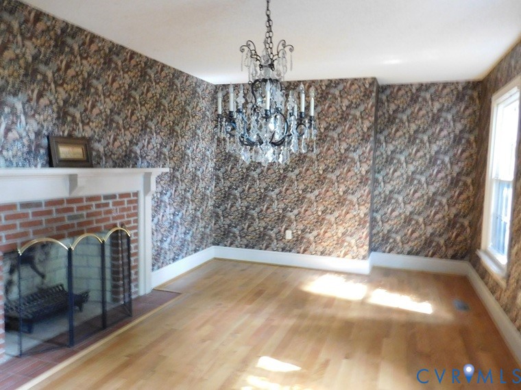 838 Crymes Road Keysville, VA 23947 - Photo 20 of 49 Unfurnished living room with wallpapered walls, a