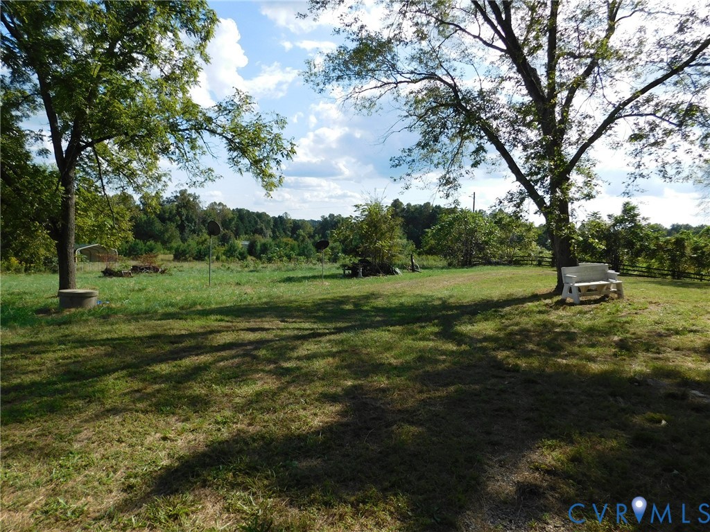 838 Crymes Road Keysville, VA 23947 - Photo 49 of 49 View of green lawn featuring a forest view