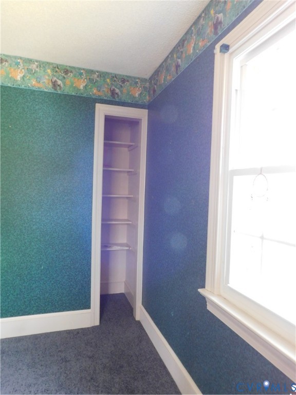 838 Crymes Road Keysville, VA 23947 - Photo 10 of 49 Spare room featuring wallpapered walls and dark ca
