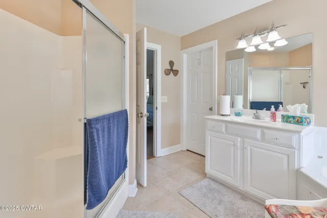 a bathroom with a sink vanity and a mirror
