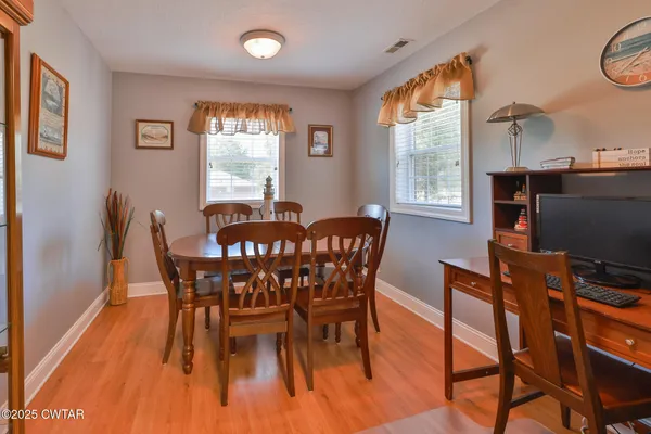 a view of a dining room with furniture window and outside view