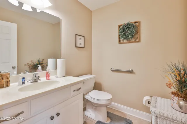 a bathroom with a sink mirror vanity and toilet