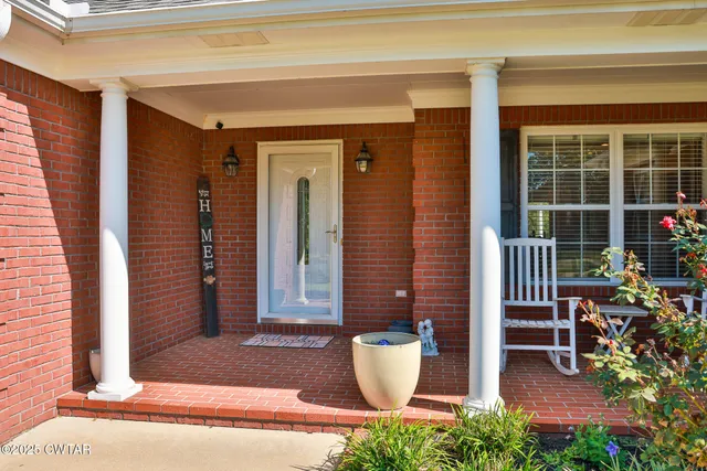 a front view of a house with outdoor seating and plants