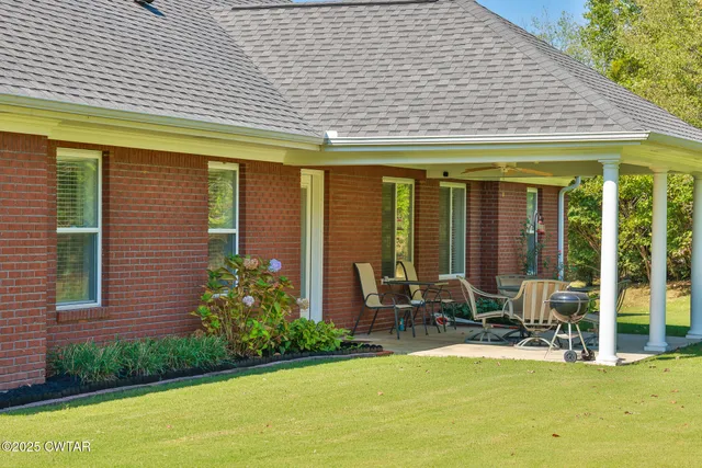 a view of a house with backyard porch and sitting area