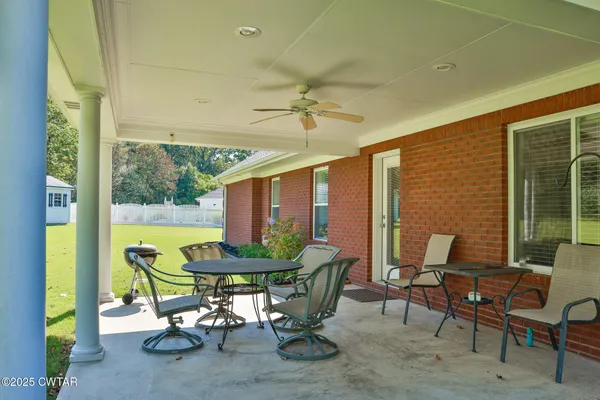 a view of a patio with a table and chairs