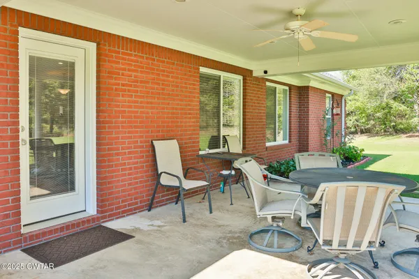 a view of a patio with table and chairs and potted plants