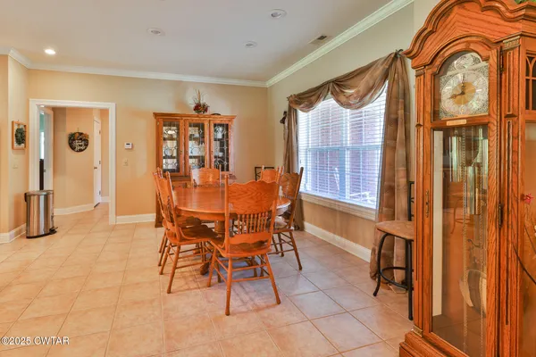 a dining room with furniture a window and a chandelier