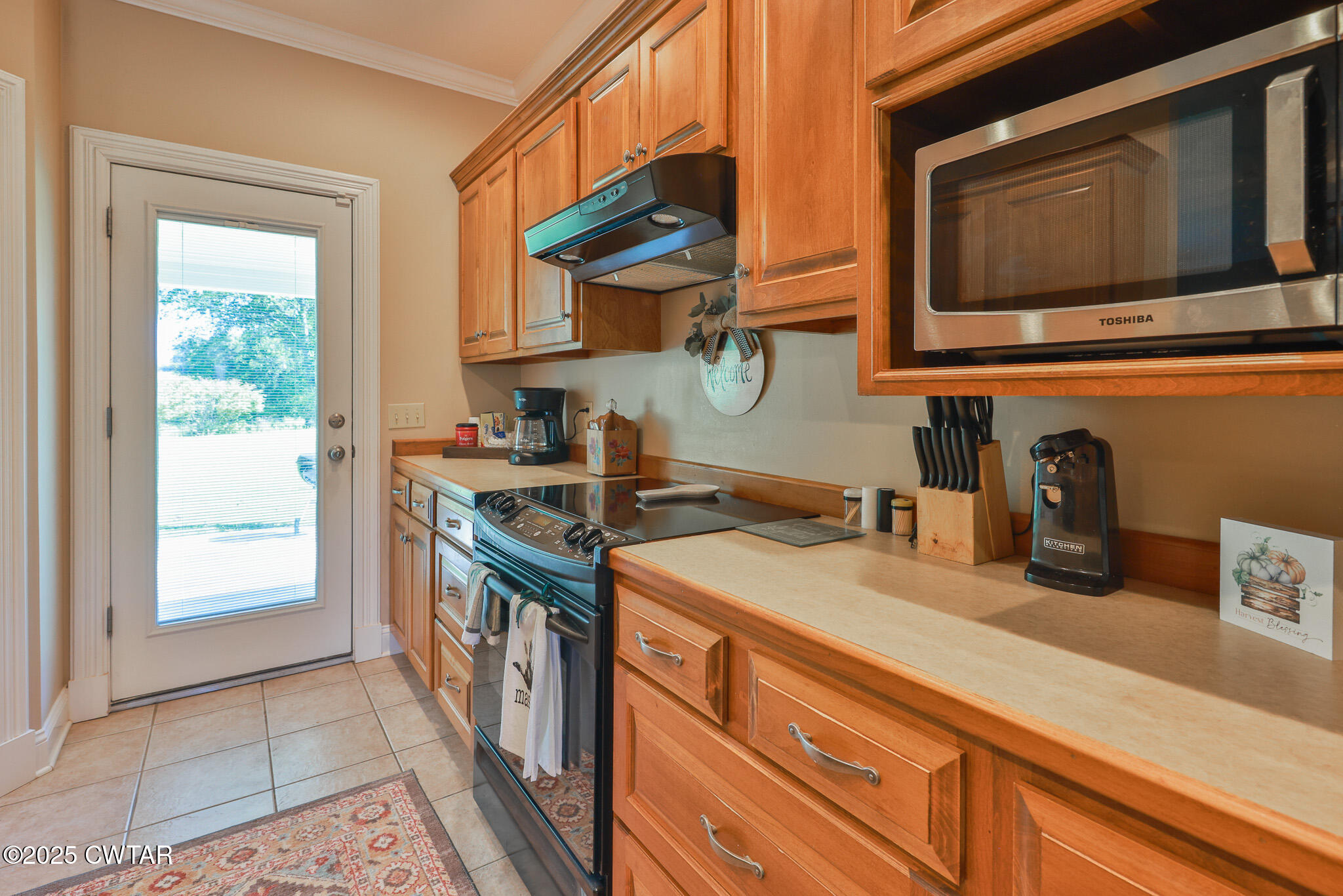 148 Scattered Acres Loop Dyer, TN 38330 - Photo 5 of 31 a kitchen with stainless steel appliances granite countertop a stove a sink and a microwave