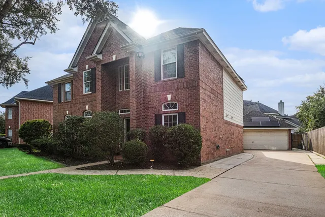 a front view of a house with a garden and plants