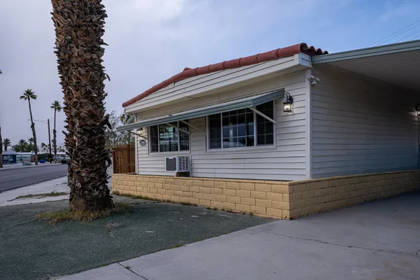 a front view of a house with trees