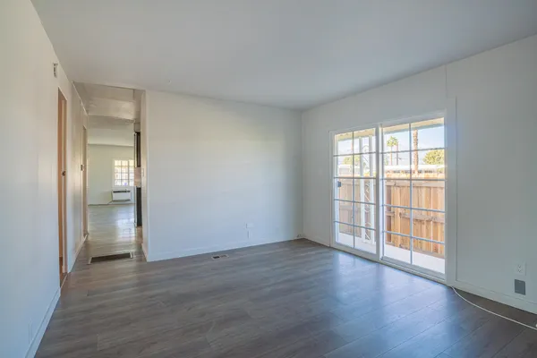 wooden floor in an empty room with a window