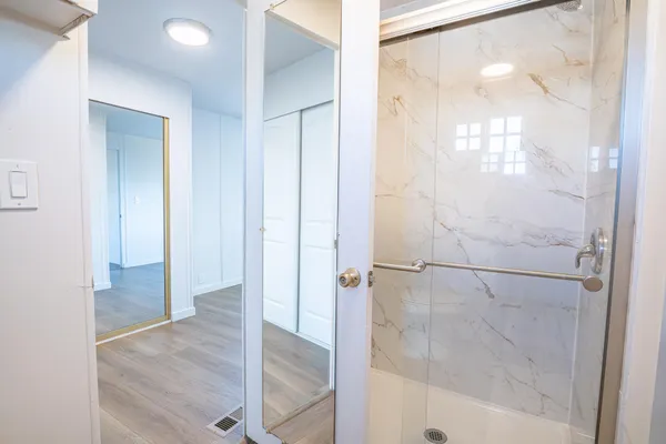 a bathroom with a glass shower door