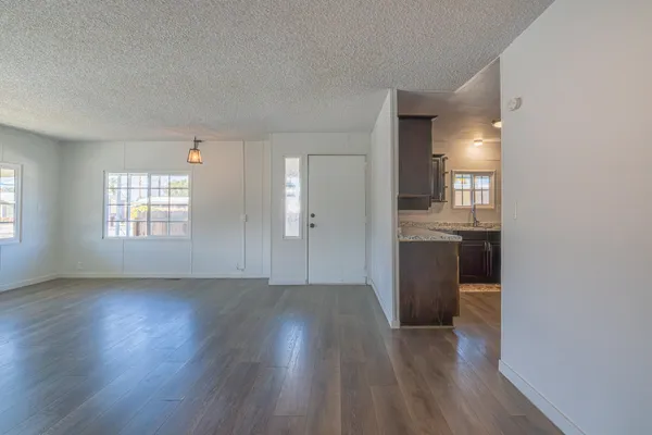 an empty room with wooden floor and a window