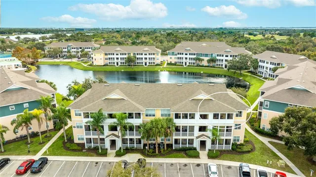 an aerial view of residential houses with outdoor space and lake view
