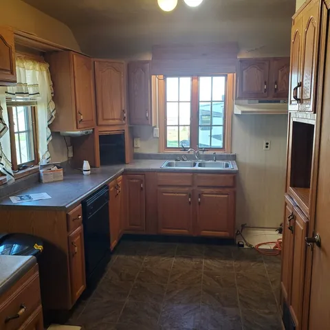 a kitchen with a sink stove and cabinets