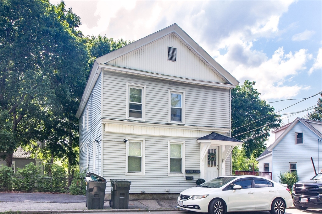 a view of a white car parked in front of a house