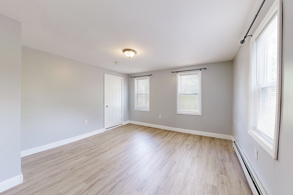 249 North Main Street Webster, MA 01570 - Photo 11 of 32 a view of an empty room with wooden floor and a window