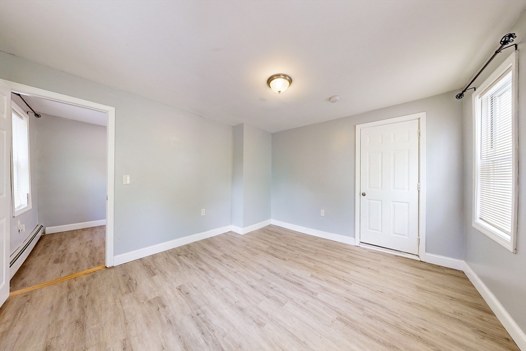 249 North Main Street Webster, MA 01570 - Photo 12 of 32 an empty room with wooden floor and windows