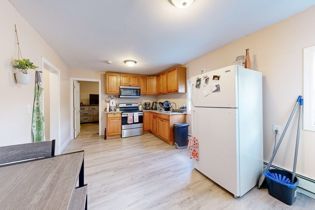 249 North Main Street Webster, MA 01570 - Photo 14 of 32 a kitchen with stainless steel appliances a refrigerator and a stove top oven