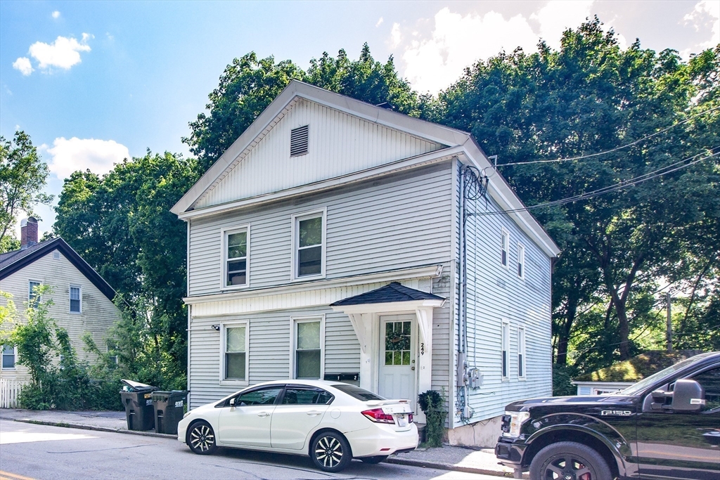 249 North Main Street Webster, MA 01570 - Photo 2 of 32 a car parked in front of a house