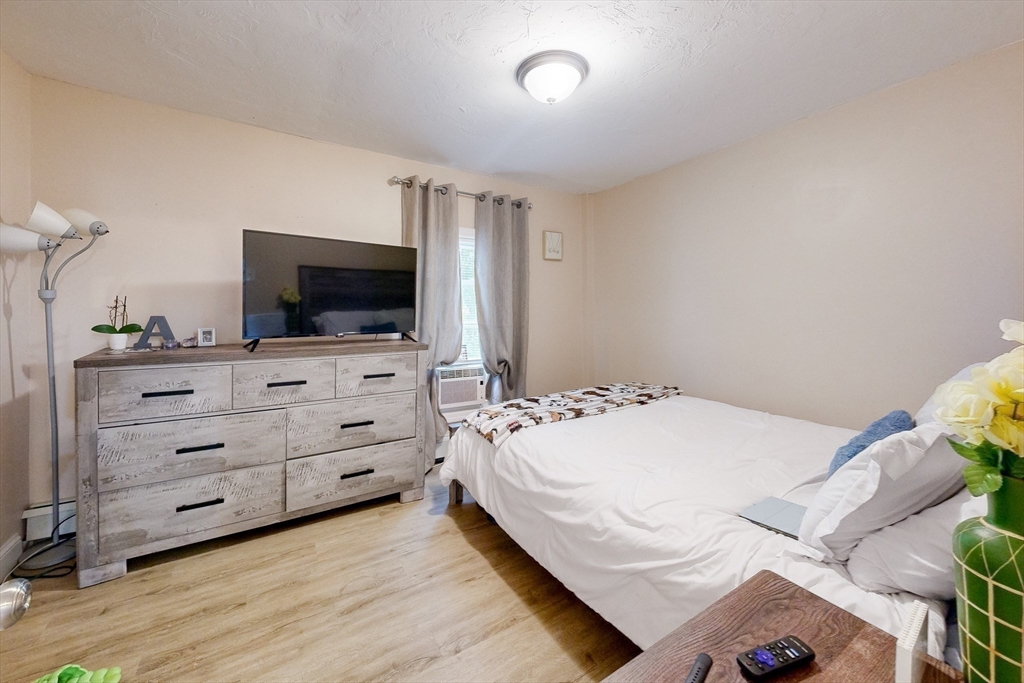 249 North Main Street Webster, MA 01570 - Photo 21 of 32 a bedroom with a bed and a flat screen tv