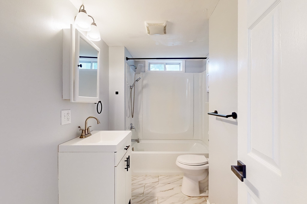 249 North Main Street Webster, MA 01570 - Photo 7 of 32 a bathroom with a toilet a sink and a mirror
