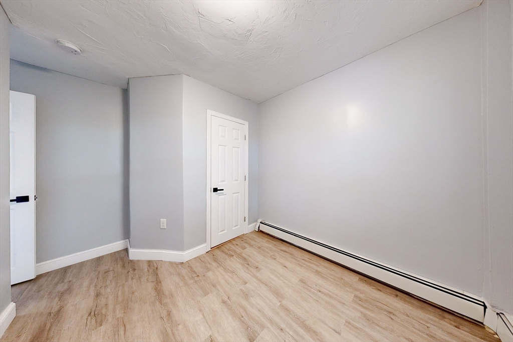 249 North Main Street Webster, MA 01570 - Photo 9 of 32 an empty room with wooden floor