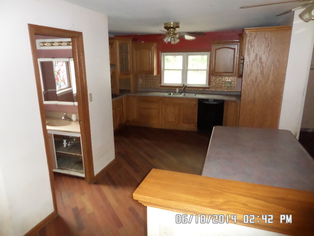 11480 Bell Road Lemont, IL 60439 - Photo 4 of 14 a kitchen with stainless steel appliances granite countertop a sink a stove a refrigerator and a wooden floor