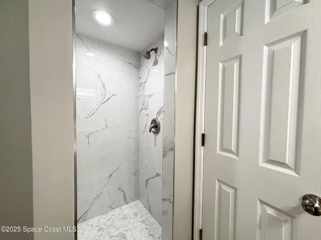 a white toilet sitting next to a bathroom sink