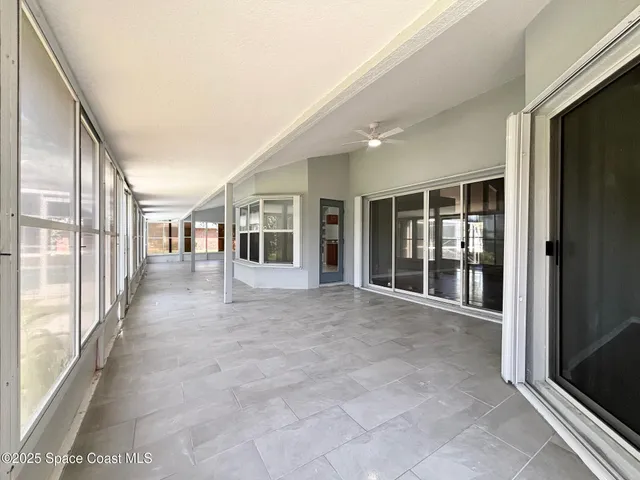 an empty room with windows and entrance