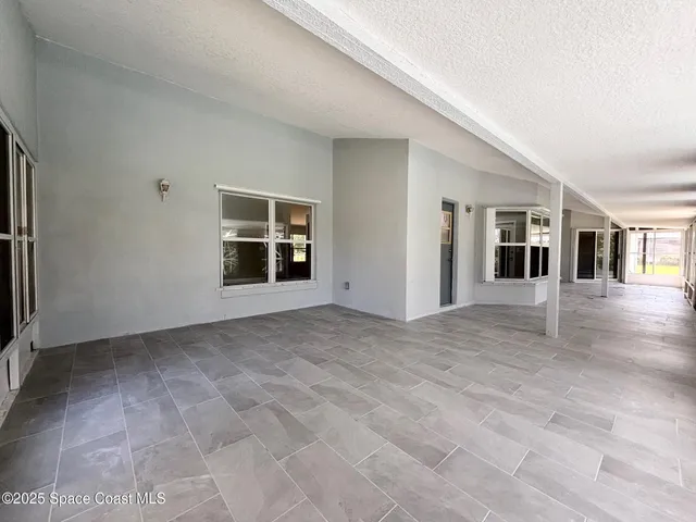 a view of a backyard with table and chairs