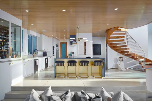 a kitchen with stainless steel appliances a stove a sink a microwave and cabinets