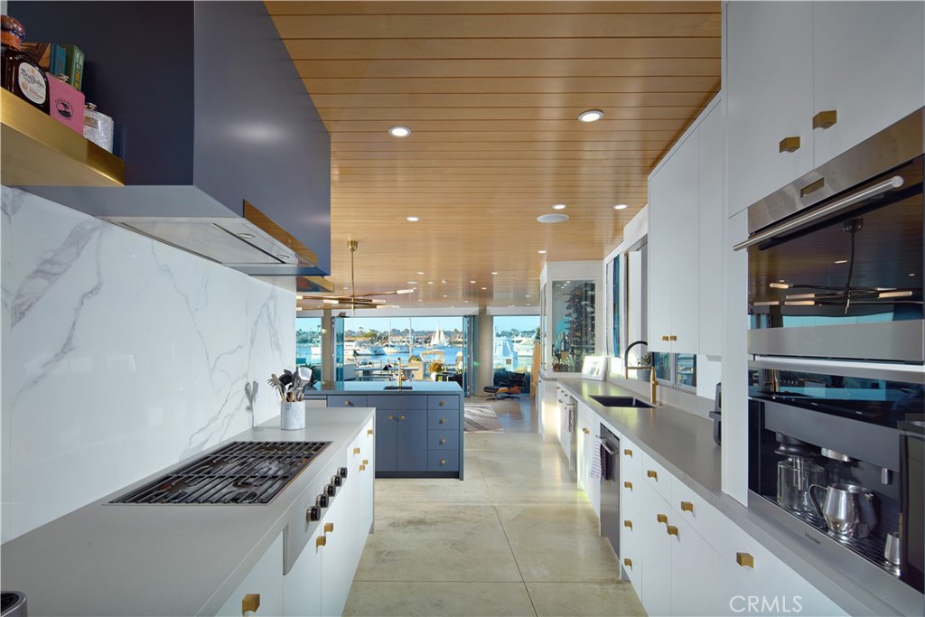 1042 West Bay Avenue Newport Beach, CA 92661 - Photo 15 of 37 a kitchen with stainless steel appliances a stove a sink a microwave and cabinets