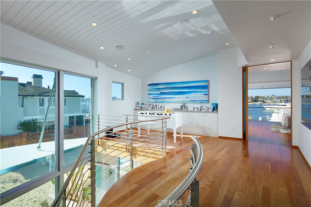 1042 West Bay Avenue Newport Beach, CA 92661 - Photo 17 of 37 a room with wooden floors and furniture