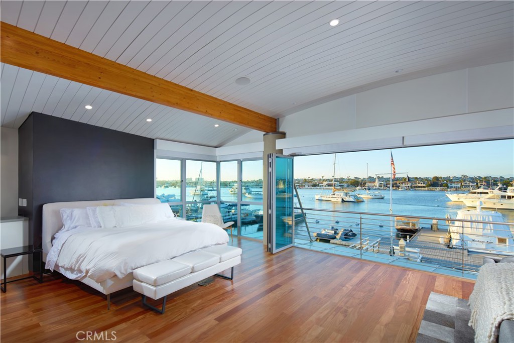 1042 West Bay Avenue Newport Beach, CA 92661 - Photo 20 of 37 a bedroom with a bed and a large window
