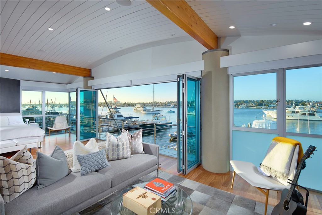 1042 West Bay Avenue Newport Beach, CA 92661 - Photo 21 of 37 a living room with furniture and a floor to ceiling window