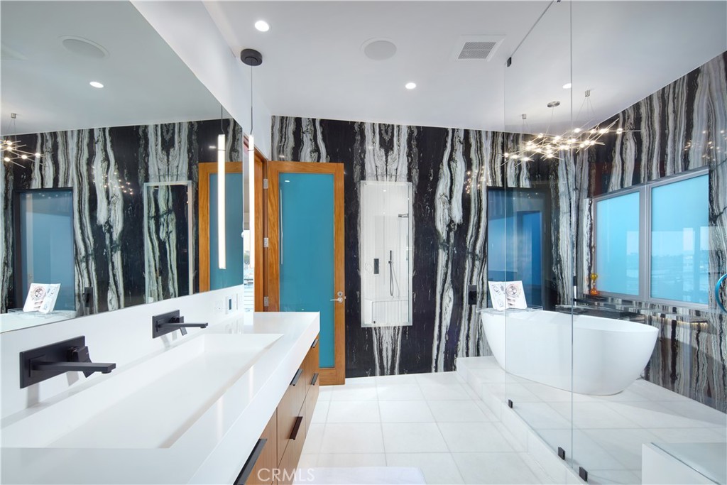 1042 West Bay Avenue Newport Beach, CA 92661 - Photo 26 of 37 a spacious bathroom with a double vanity sink a large mirror and shower